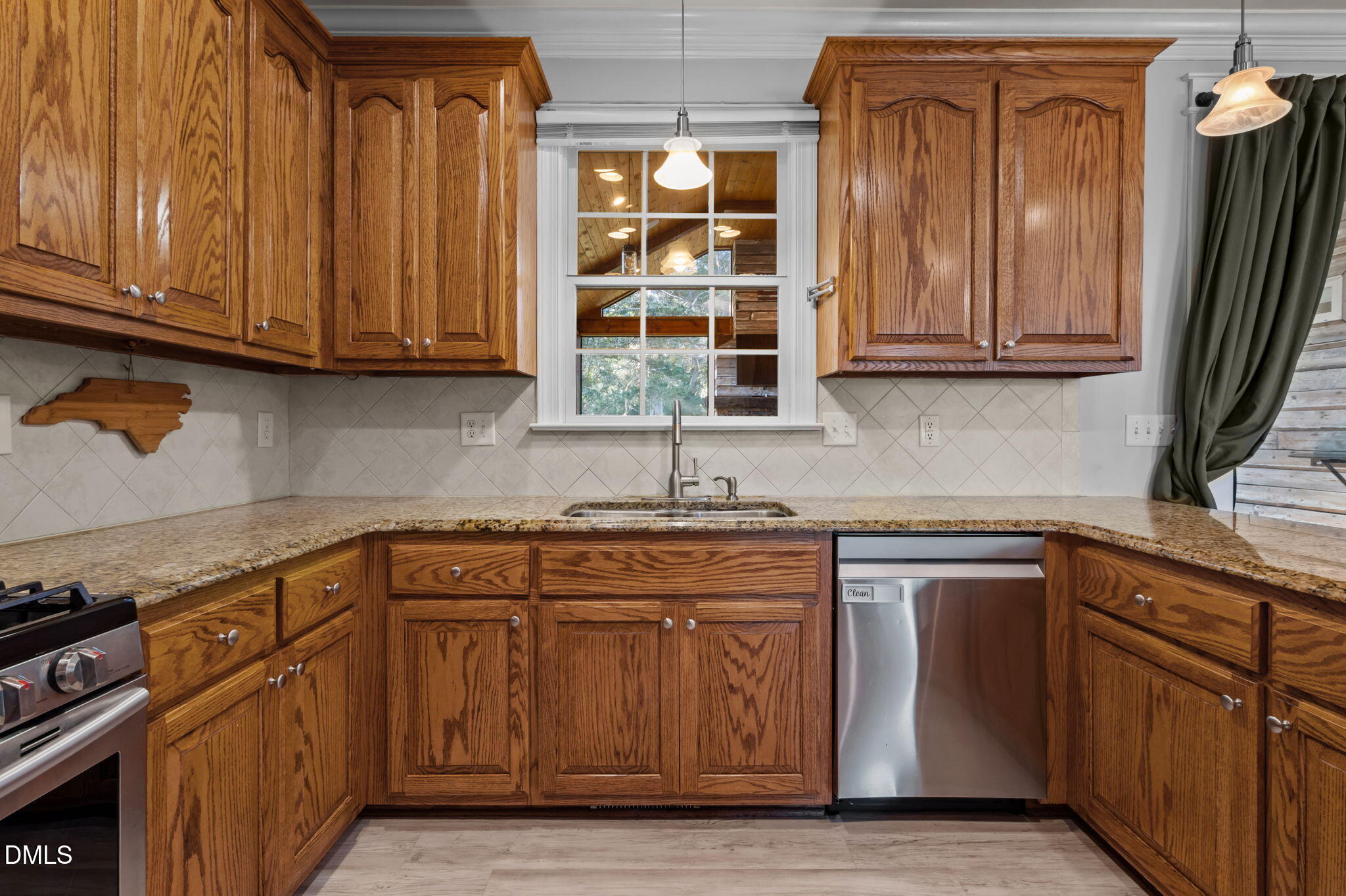 236 Derwin Drive Timberlake, NC 27583 - Photo 27 of 45 a kitchen with stainless steel appliances granite countertop wooden cabinets a sink and dishwasher