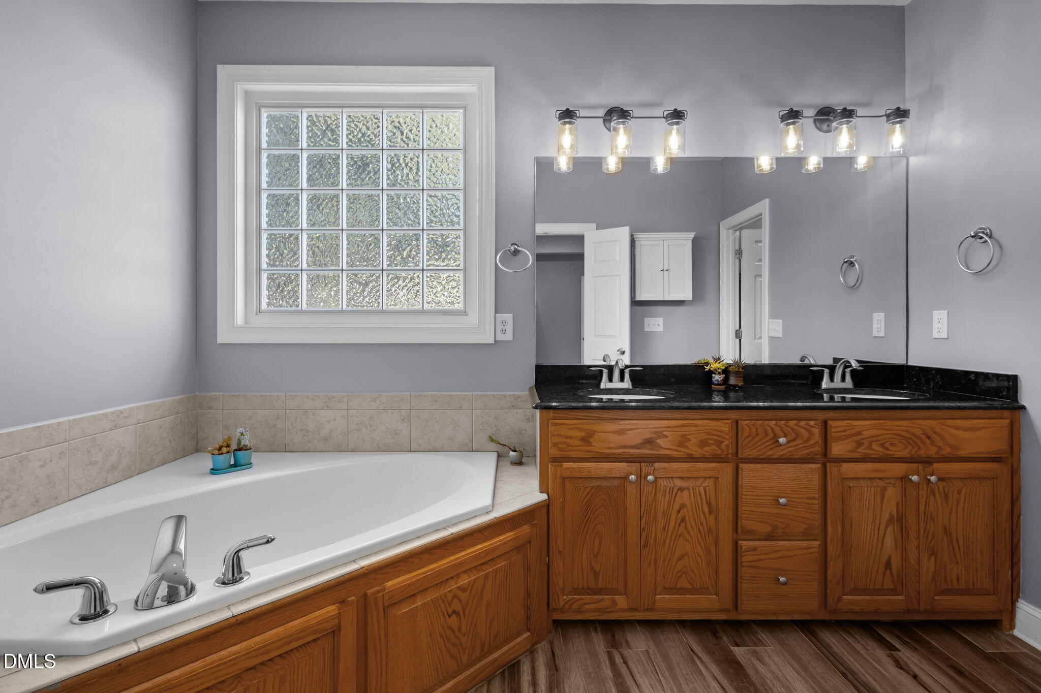 236 Derwin Drive Timberlake, NC 27583 - Photo 31 of 45 a spacious bathroom with double vanity and a large mirror