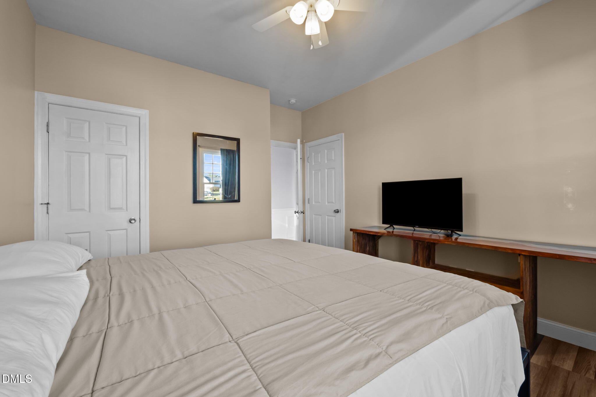 236 Derwin Drive Timberlake, NC 27583 - Photo 34 of 45 a bedroom with a bed and a flat screen tv