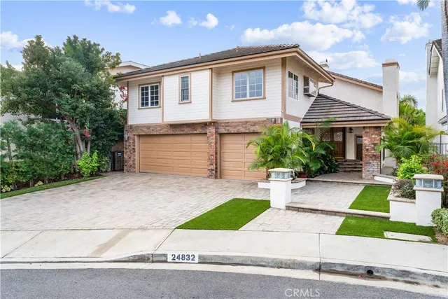 a front view of a house with a yard and a garage