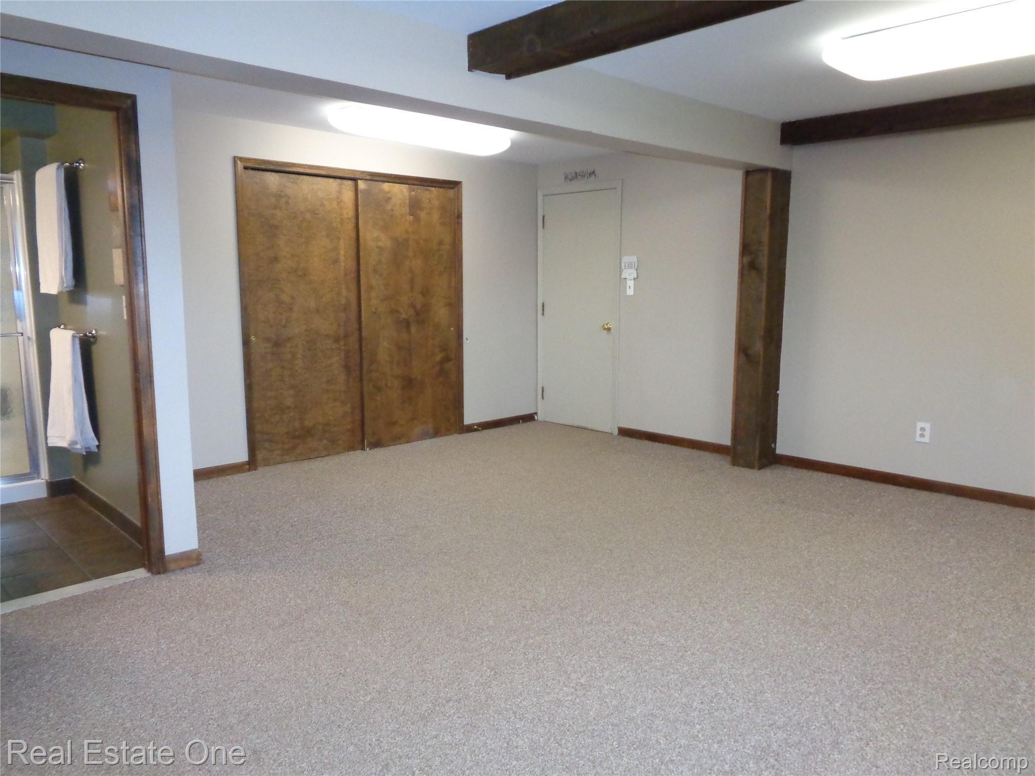 2572 Lake George Road Oakland, MI 48363 - Photo 46 of 83 Recreation space with deep closet for additional storage. Direct access door to right leads into oversized, heated, attached garage.