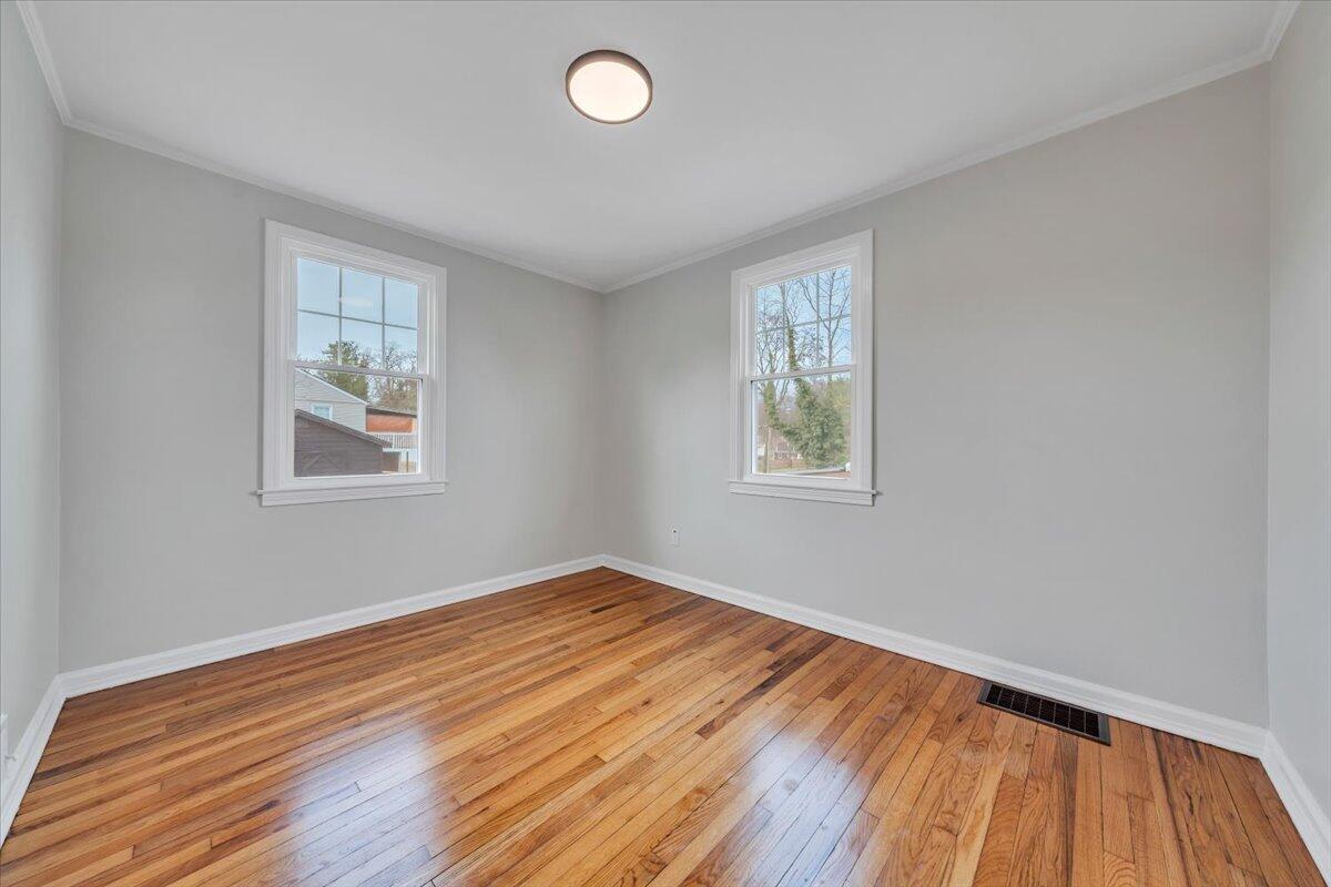 1004 26th Street Southwest Roanoke, VA 24015 - Photo 13 of 27 a view of a room with wooden floor and windows