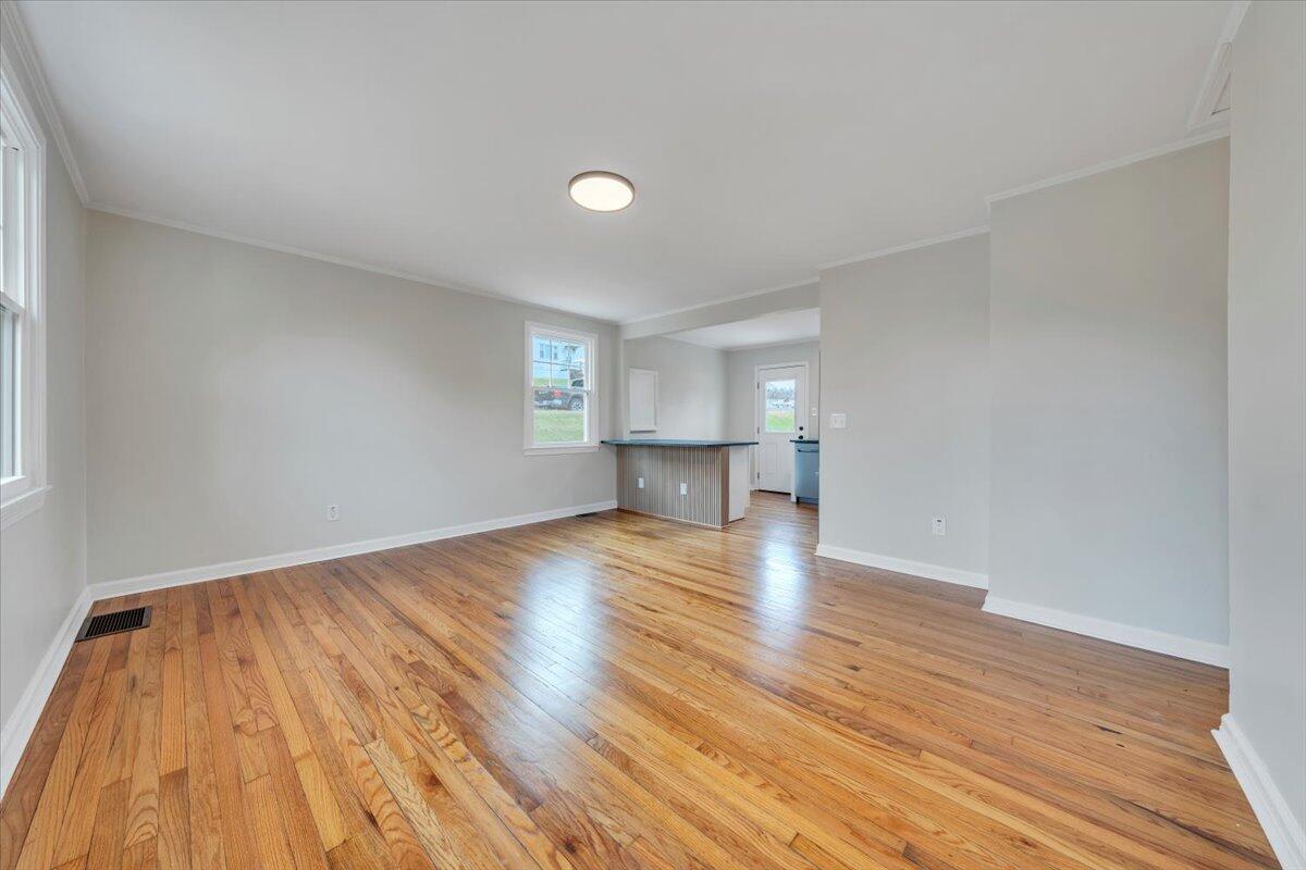1004 26th Street Southwest Roanoke, VA 24015 - Photo 3 of 27 a view of empty room with wooden floor and fan