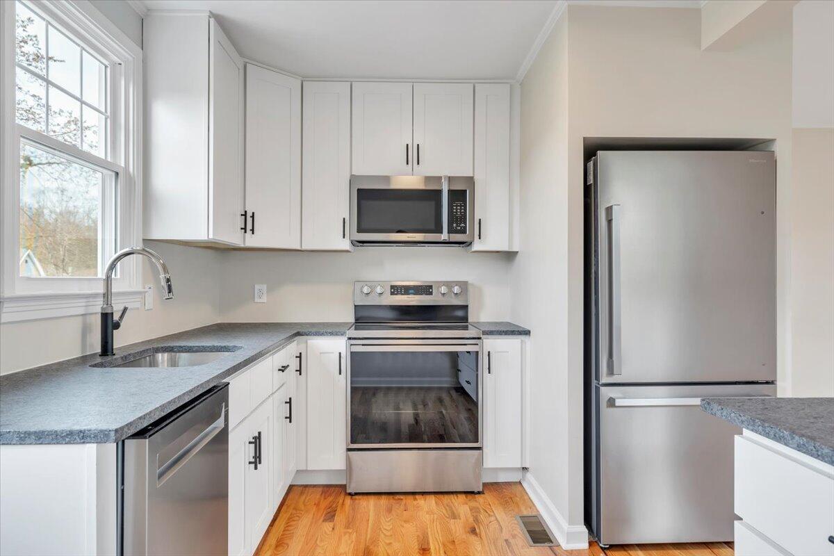 1004 26th Street Southwest Roanoke, VA 24015 - Photo 9 of 27 a kitchen with a refrigerator stove and microwave