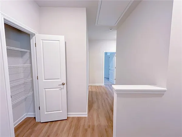 a view of empty room with wooden floor