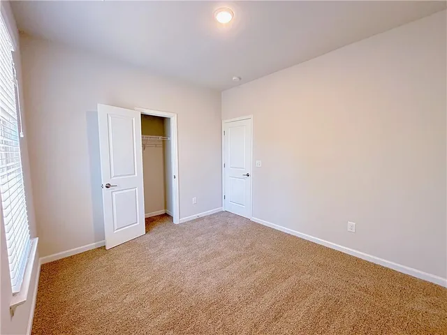 an empty room with closet area