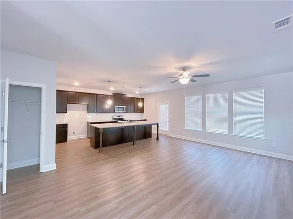 a view of kitchen with cabinets and wooden floor