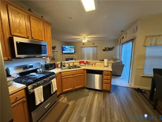 a kitchen with stainless steel appliances granite countertop a stove a sink dishwasher a microwave oven with granite countertops and cabinets