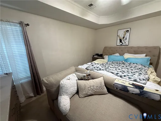 a bedroom with a bed and a couch