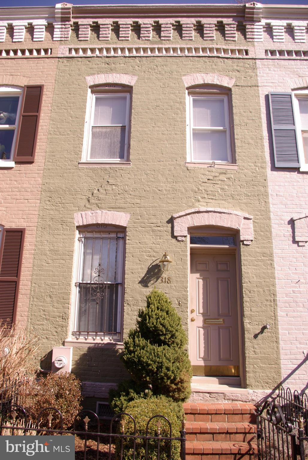 318 11th Street Southeast Washington, DC 20003 - Photo 1 of 26 a front view of a house with a yard