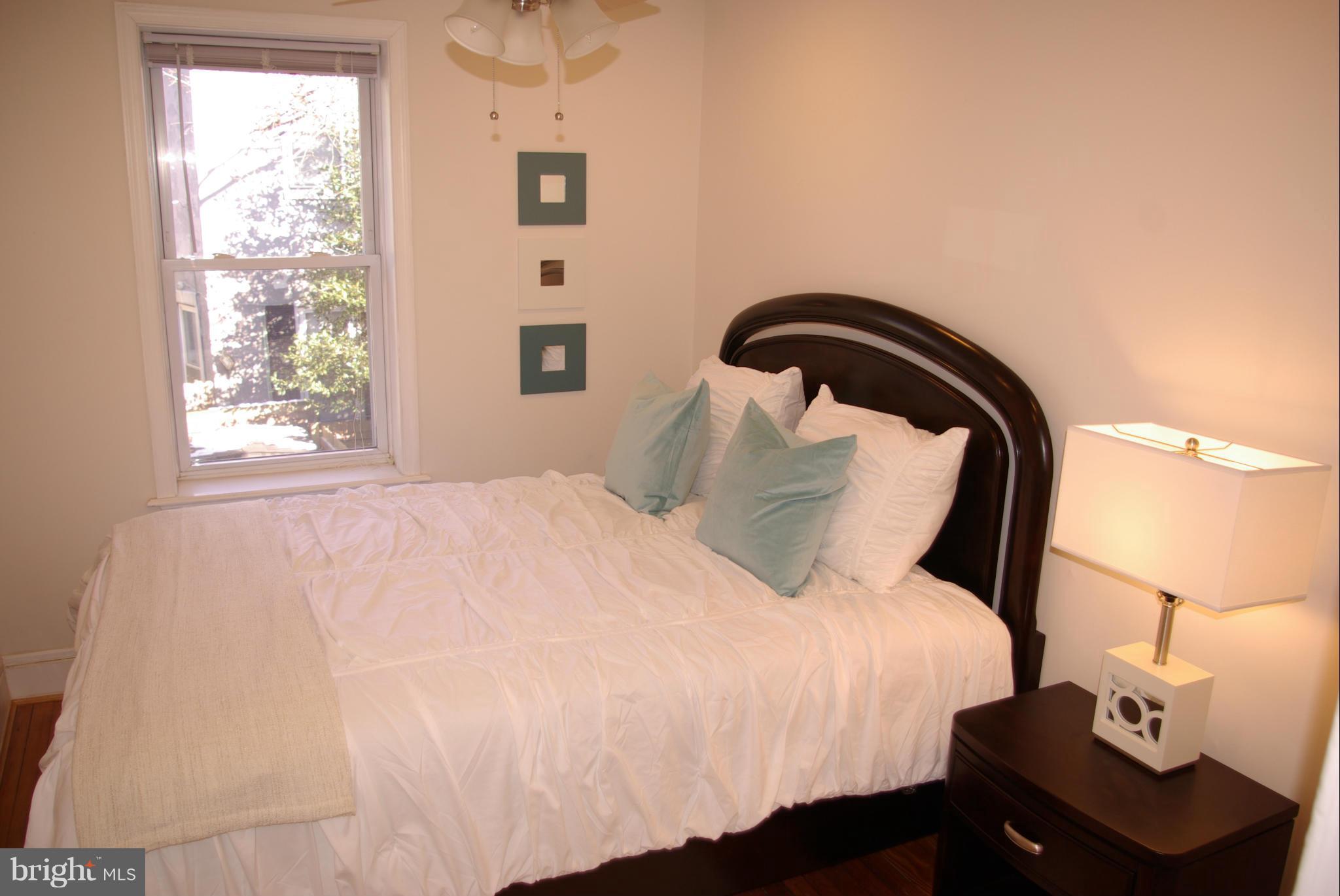 318 11th Street Southeast Washington, DC 20003 - Photo 19 of 26 a bedroom with a bed and a window