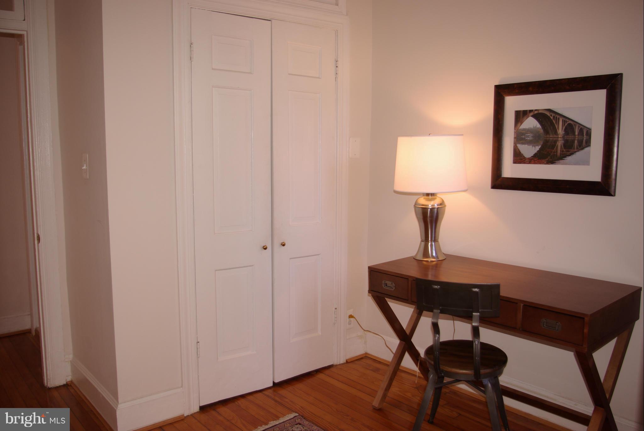 318 11th Street Southeast Washington, DC 20003 - Photo 21 of 26 a view of a workspace room with wooden floor and table lamp
