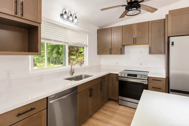 a kitchen with a sink appliances and cabinets
