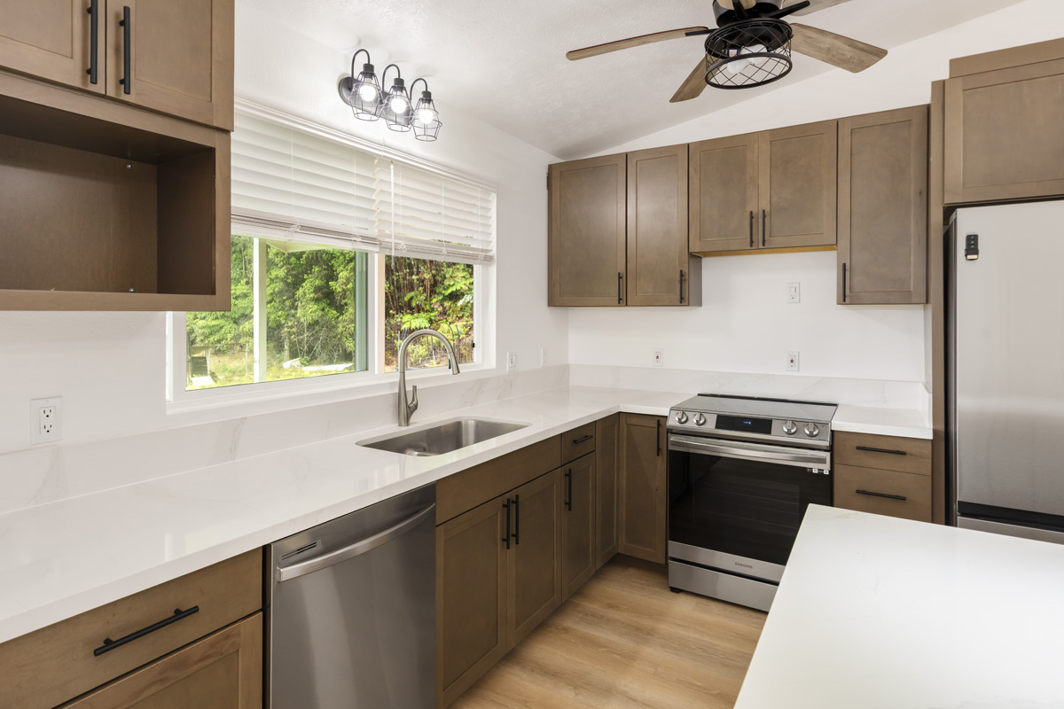 18-1465 Ihope Road Mountain View, HI 96771 - Photo 13 of 30 a kitchen with a sink appliances and cabinets