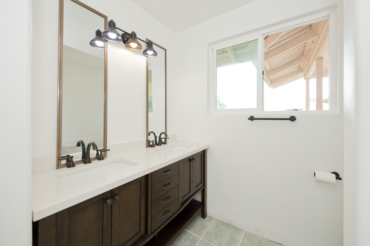 18-1465 Ihope Road Mountain View, HI 96771 - Photo 19 of 30 a bathroom with a double vanity sink a mirror and a shower
