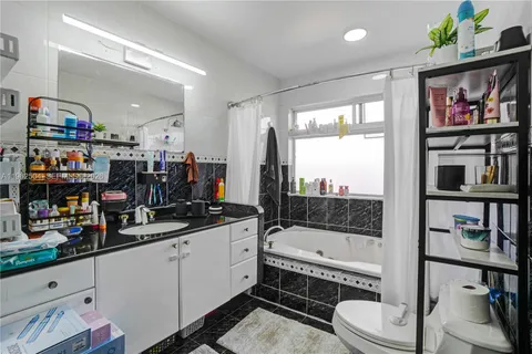 a bathroom with a sink a bathtub and a shower