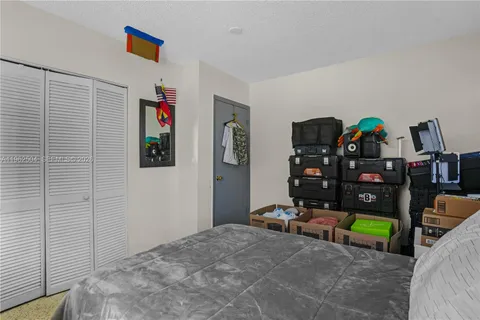 a view of a bedroom with workspace and toys