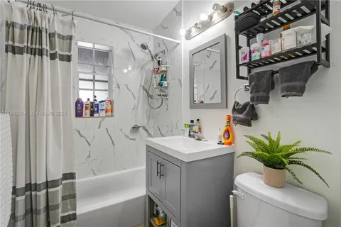 a bathroom with a sink a vanity and a shower