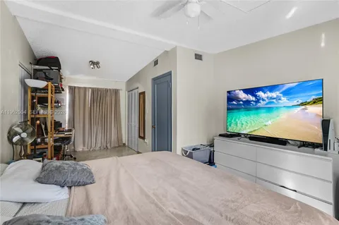 a bedroom with furniture and a flat screen tv