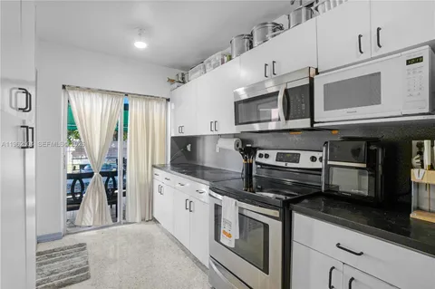 a kitchen with stainless steel appliances granite countertop a stove and a microwave