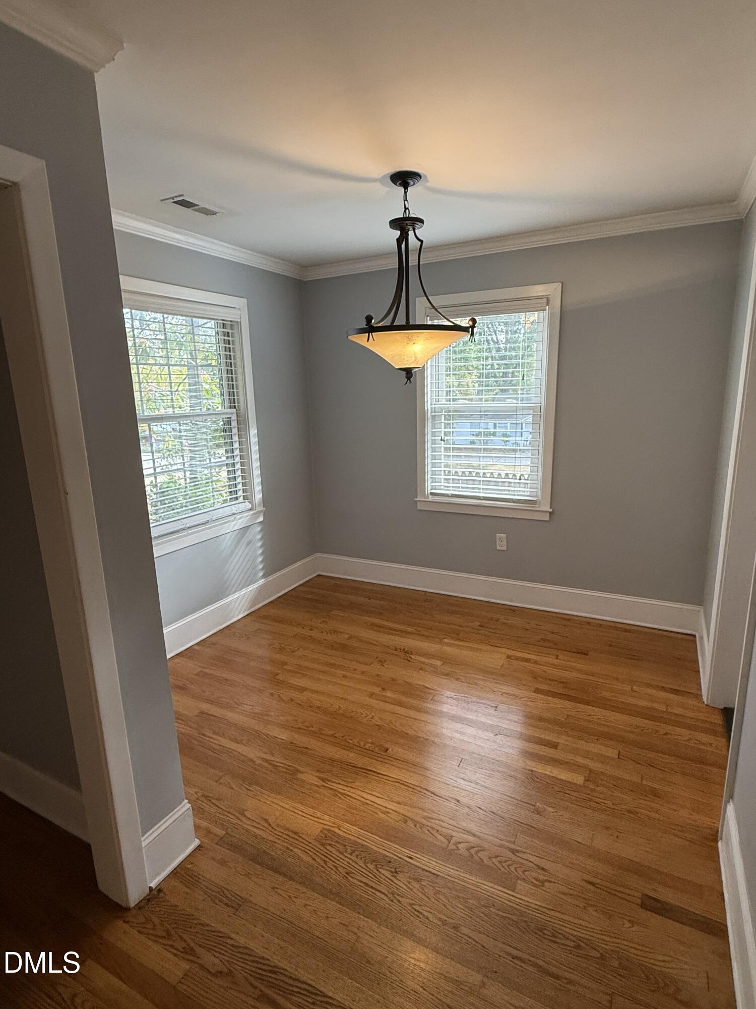 403 Brooks Avenue Raleigh, NC 27607 - Photo 4 of 9 a view of empty room with wooden floor and fan