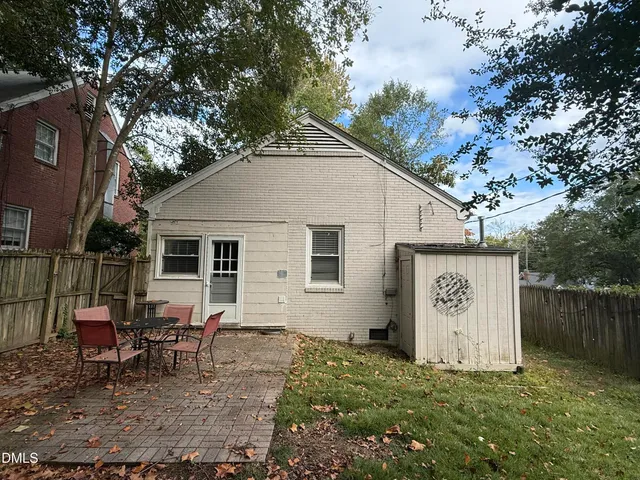 a view of a house with a yard and sitting area