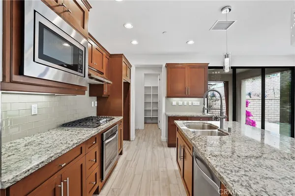 a kitchen with stainless steel appliances granite countertop a sink and stove