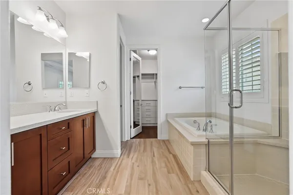 a spacious bathroom with a tub sink shower and mirror