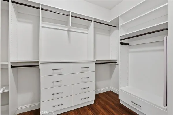 a view of walk in closet with empty racks