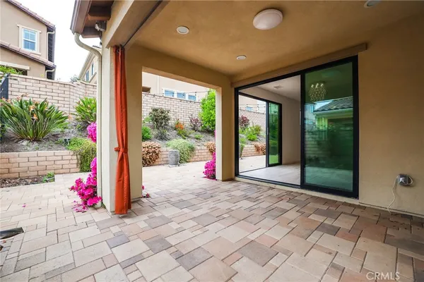 a view of a porch with furniture and floor to ceiling window