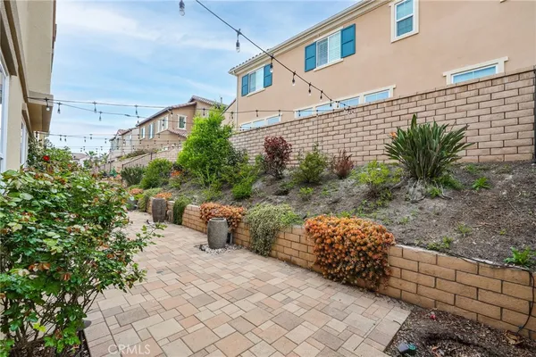 a view of backyard with outdoor seating and plants