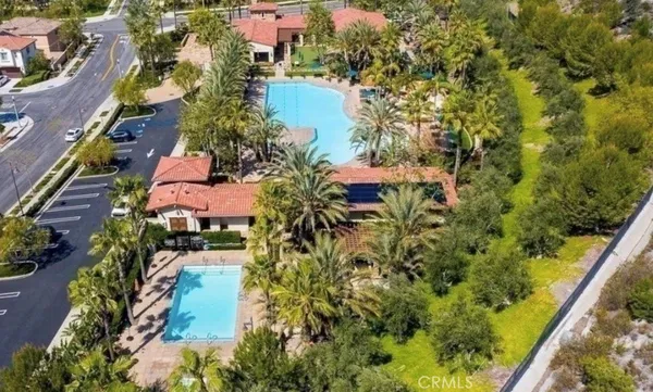 an aerial view of residential house with outdoor space and trees all around
