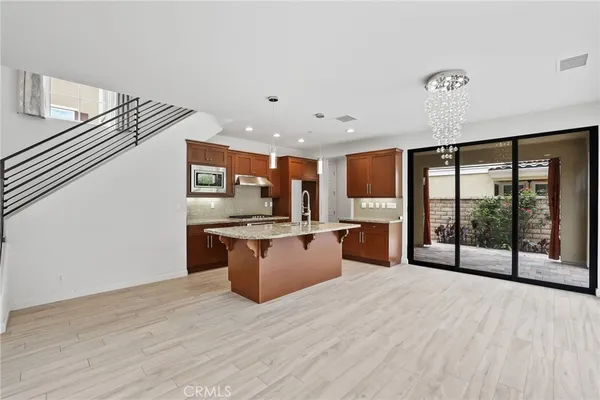 a large kitchen with stainless steel appliances kitchen island a large counter space