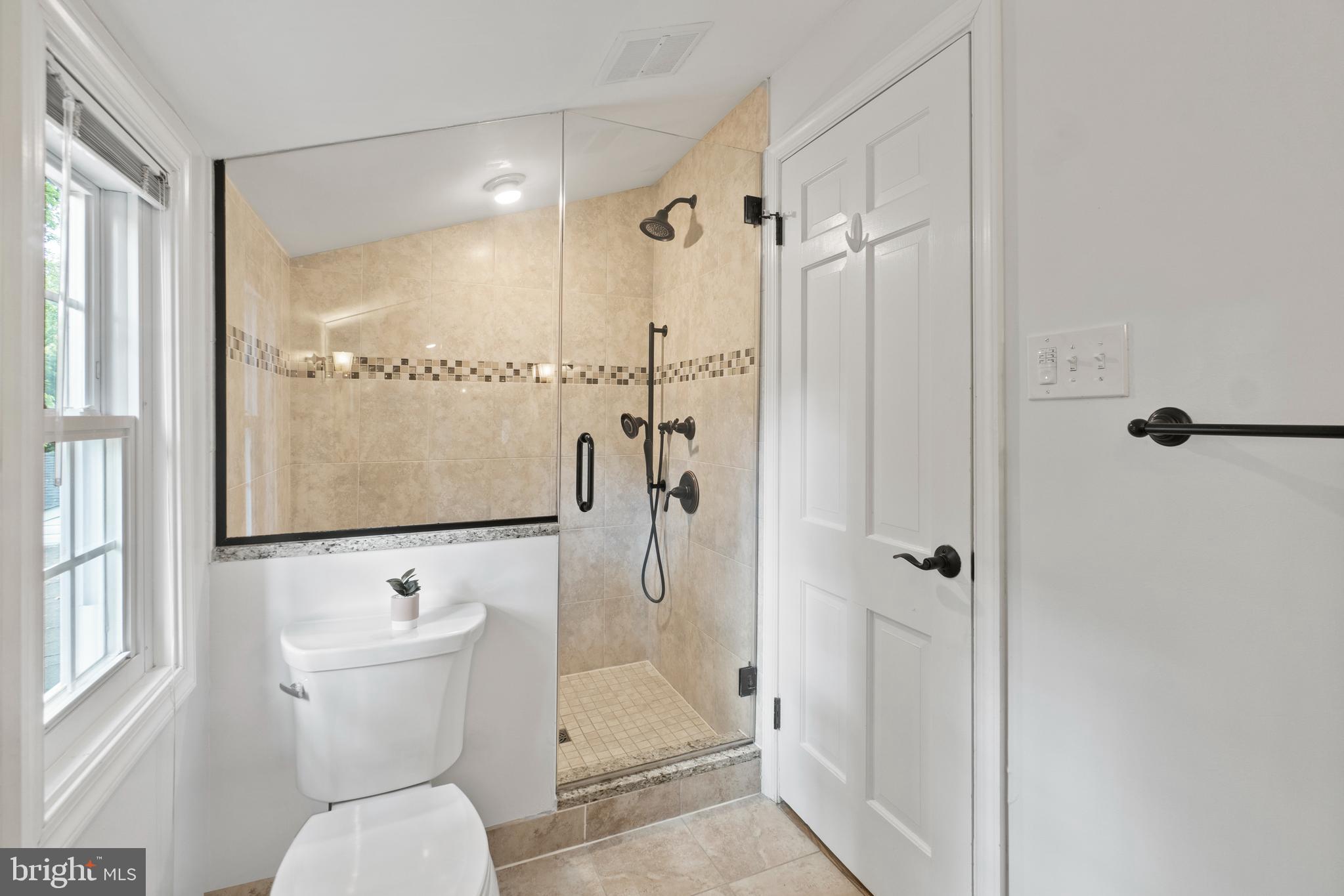 8821 Sundale Drive Silver Spring, MD 20910 - Photo 13 of 27 a bathroom with a shower toilet and sink