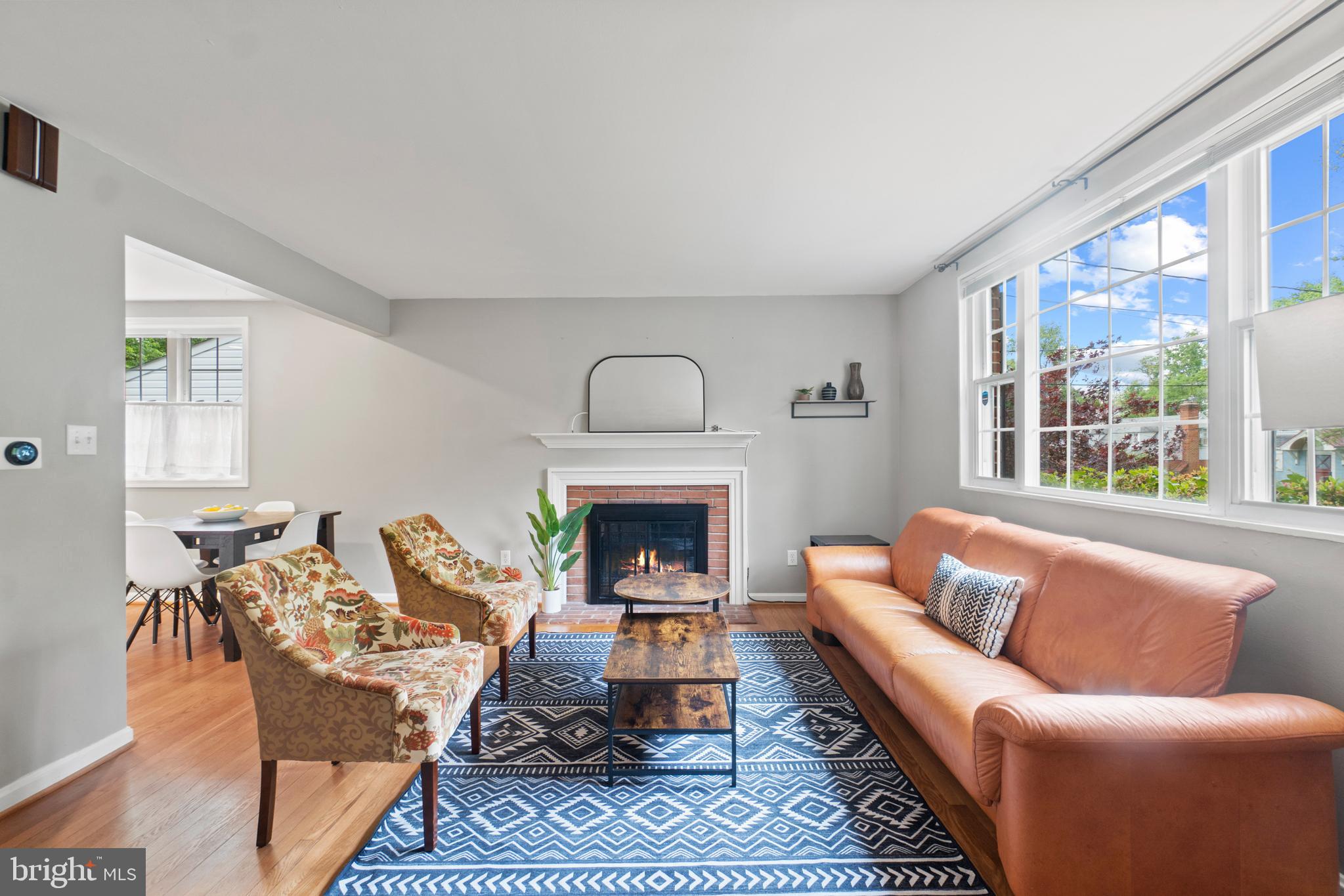 8821 Sundale Drive Silver Spring, MD 20910 - Photo 2 of 27 a living room with furniture a fireplace and a large window