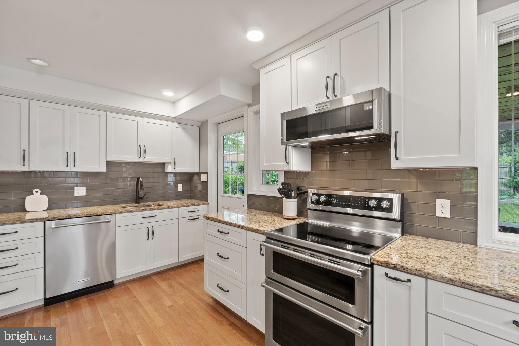 8821 Sundale Drive Silver Spring, MD 20910 - Photo 7 of 27 a kitchen with stainless steel appliances granite countertop a sink and stove top oven