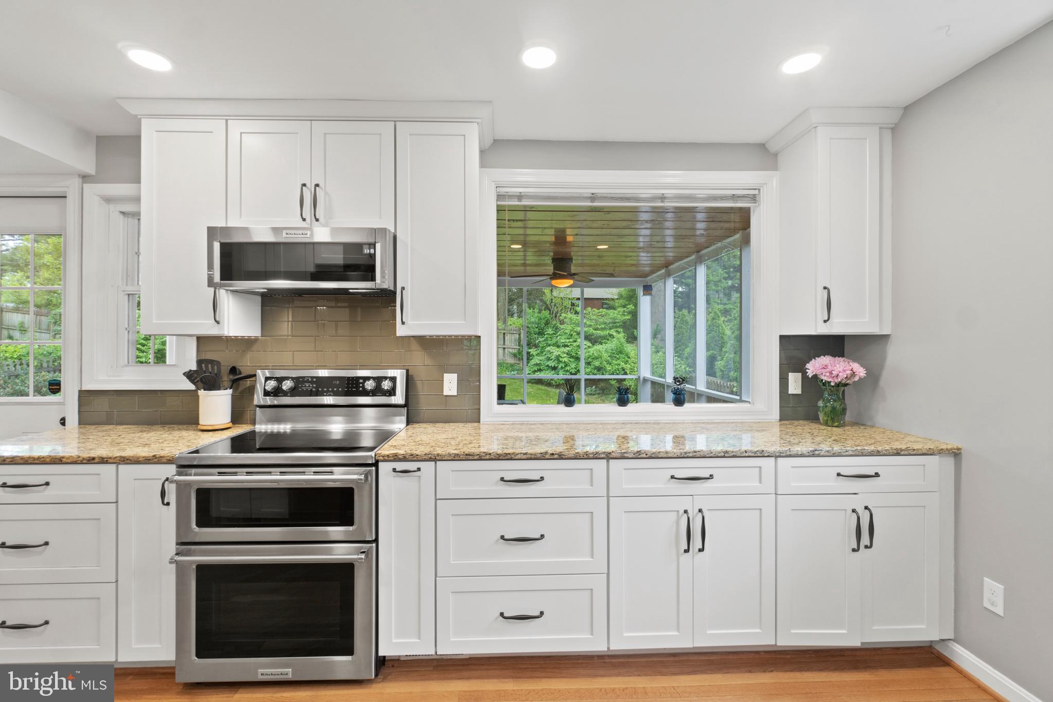 8821 Sundale Drive Silver Spring, MD 20910 - Photo 8 of 27 a kitchen with granite countertop a stove a sink and a microwave
