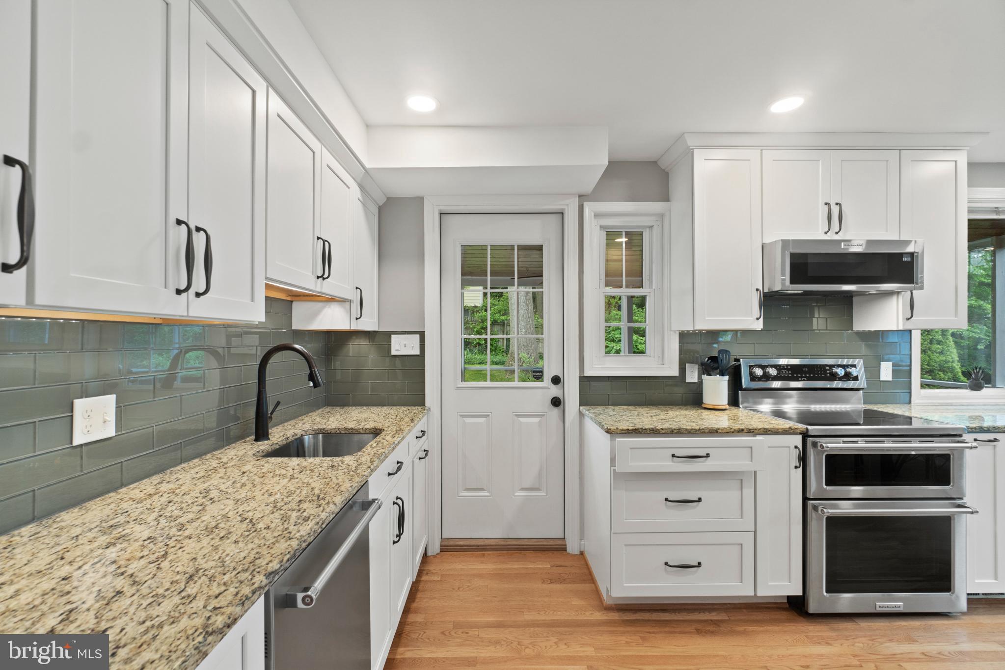 8821 Sundale Drive Silver Spring, MD 20910 - Photo 9 of 27 a kitchen with stainless steel appliances granite countertop a sink stove and refrigerator