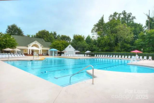 a view of swimming pool and trees in the background