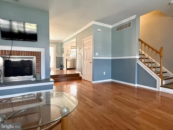 a view of a livingroom with an empty space and a kitchen
