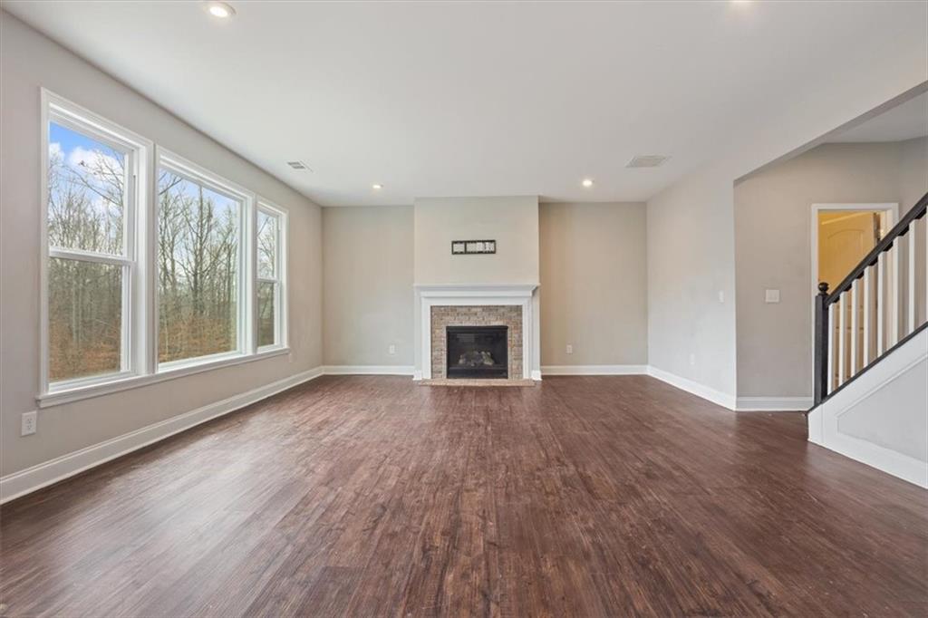 129 Rex Avenue Canton, GA 30114 - Photo 11 of 66 a view of an empty room with wooden floor and a window
