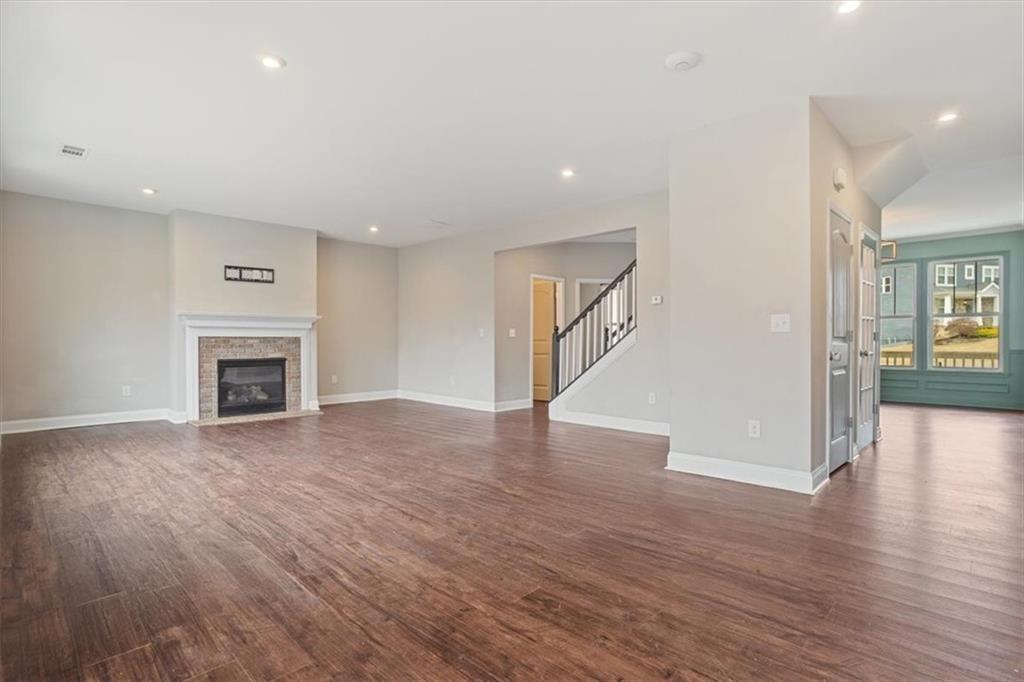 129 Rex Avenue Canton, GA 30114 - Photo 12 of 66 a view of a livingroom with wooden floor and a fireplace