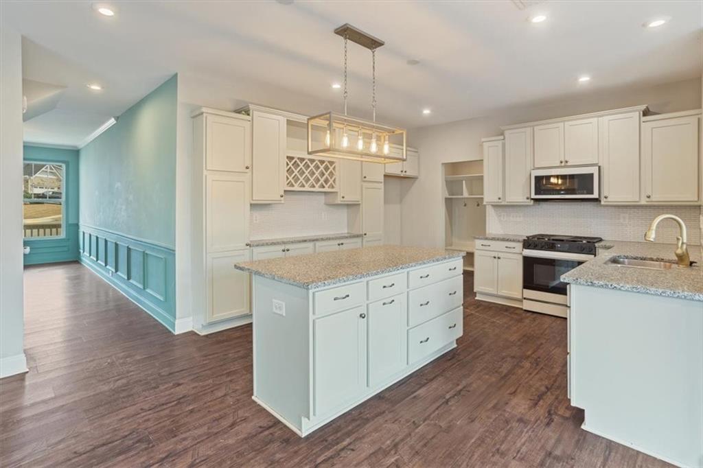 129 Rex Avenue Canton, GA 30114 - Photo 16 of 66 a kitchen with stainless steel appliances granite countertop a stove a sink a refrigerator and white cabinets with wooden floor
