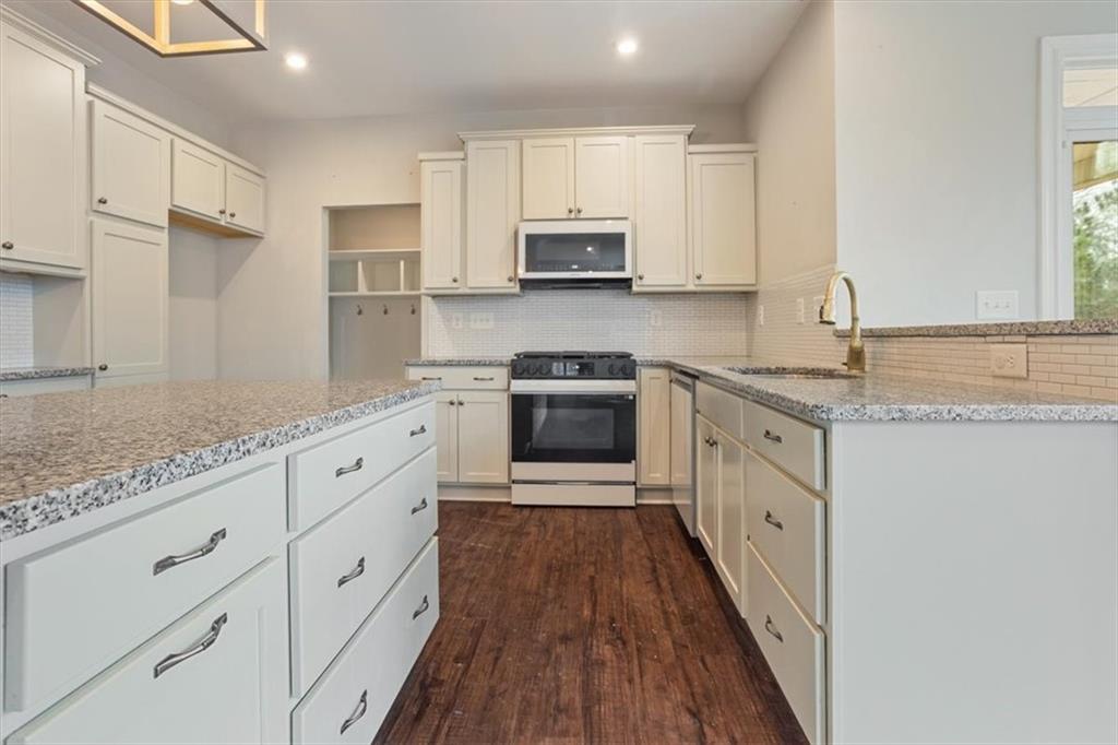 129 Rex Avenue Canton, GA 30114 - Photo 17 of 66 a kitchen with granite countertop white cabinets stainless steel appliances a sink and a counter space