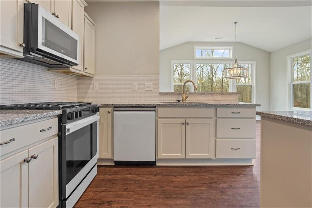 129 Rex Avenue Canton, GA 30114 - Photo 18 of 66 a kitchen with granite countertop white cabinets stainless steel appliances and sink