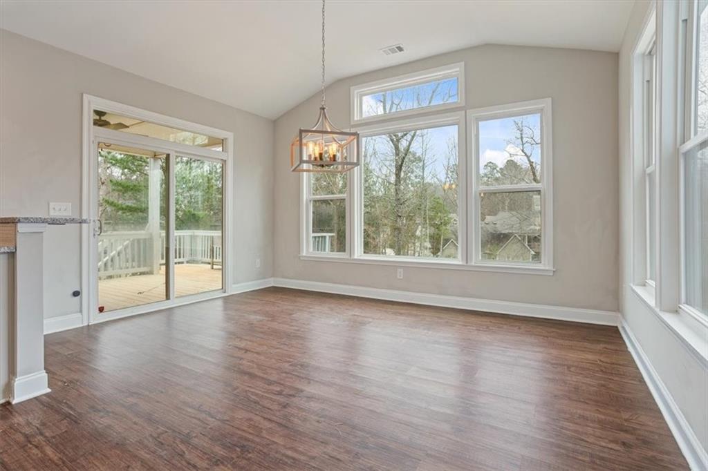 129 Rex Avenue Canton, GA 30114 - Photo 22 of 66 a view of an empty room with wooden floor and a window