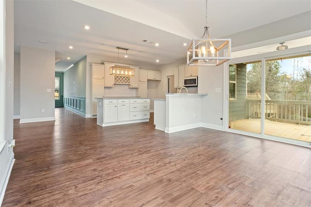 129 Rex Avenue Canton, GA 30114 - Photo 23 of 66 a view of a kitchen with granite countertop wooden floor and stainless steel appliances