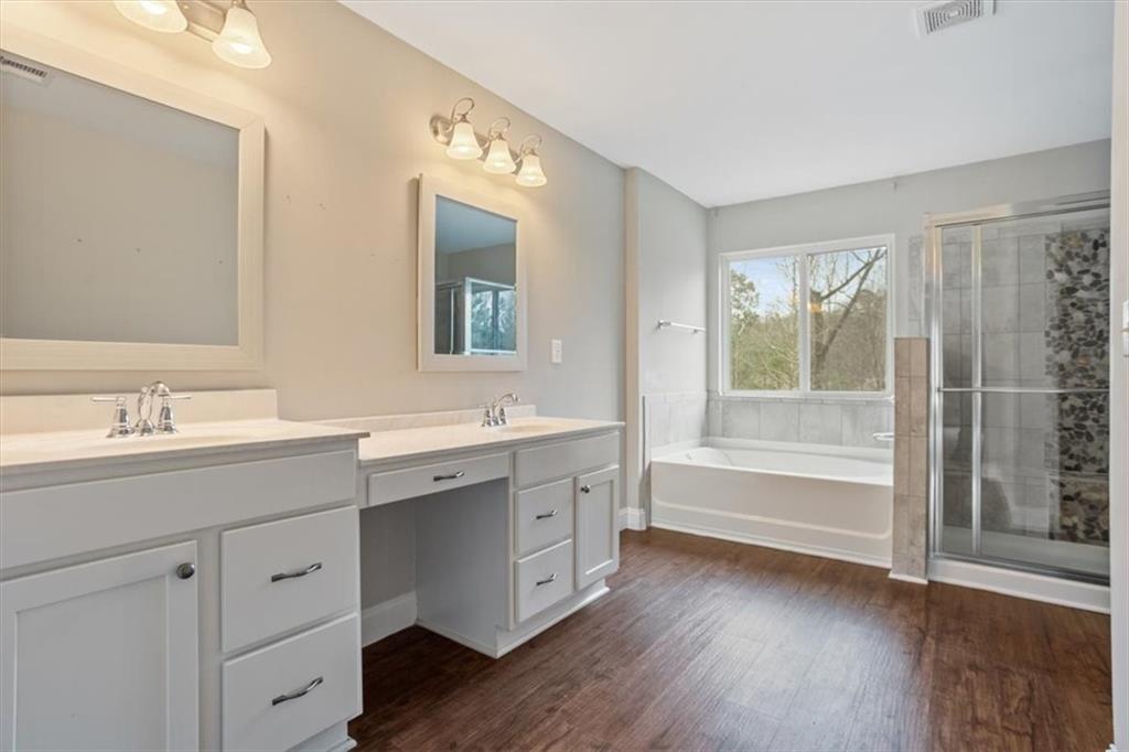 129 Rex Avenue Canton, GA 30114 - Photo 34 of 66 a spacious bathroom with a double vanity sink a large mirror and a bathtub