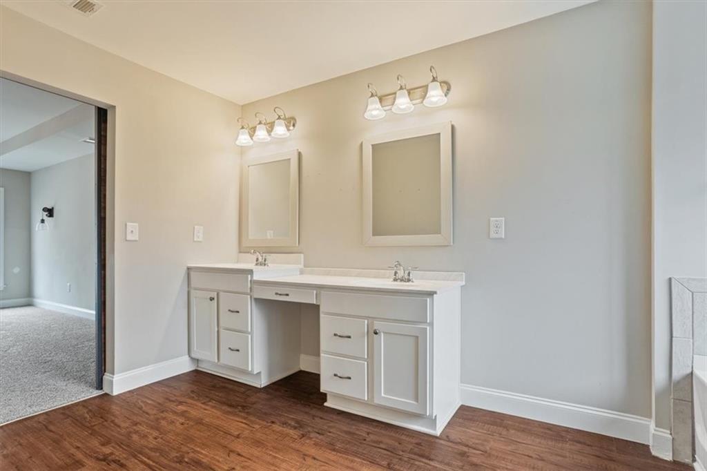 129 Rex Avenue Canton, GA 30114 - Photo 36 of 66 a spacious bathroom with a double vanity sink a mirror and a
