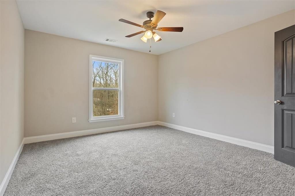 129 Rex Avenue Canton, GA 30114 - Photo 39 of 66 an empty room with windows and fan